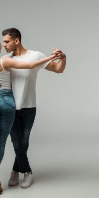 stock-photo-dancers-denim-jeans-dancing-bachata-grey-background (1)